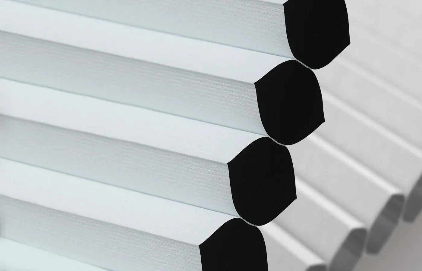 Blackout Honeycomb-structured fabric providing sound insulation, thermal insulation, energy efficiency, and all-season comfort.