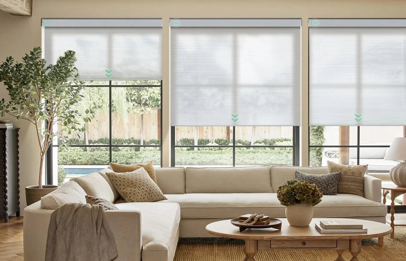 White motorized light-filtering cellular shades in the living room, controllable by voice and able to operate multiple shades simultaneously.