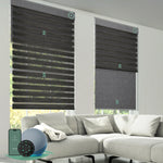 Motorized dual roller shades combining room darkening zebra black fabric and blackout dark grey fabric with smart control.