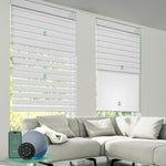 Motorized dual roller shades combining room darkening zebra white fabric and blackout jacquard white fabric with smart control.