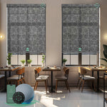 Motorized solar roller shades with 5% openness geometric black fabric, blocking glare and UV while preserving a clean view